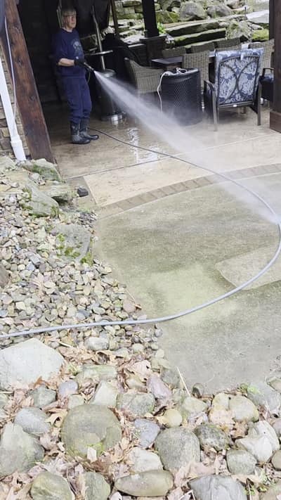 Power washing a concrete patio